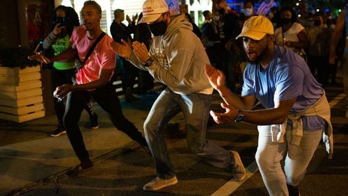 People dance in the streets to celebrate President-elect Joe Biden’s victory over Donald Trump in the U.S. general election in Midtown Atlanta, on Saturday, Nov. 7, 2020. (Rebecca Wright for The Atlanta Journal-Constitution)