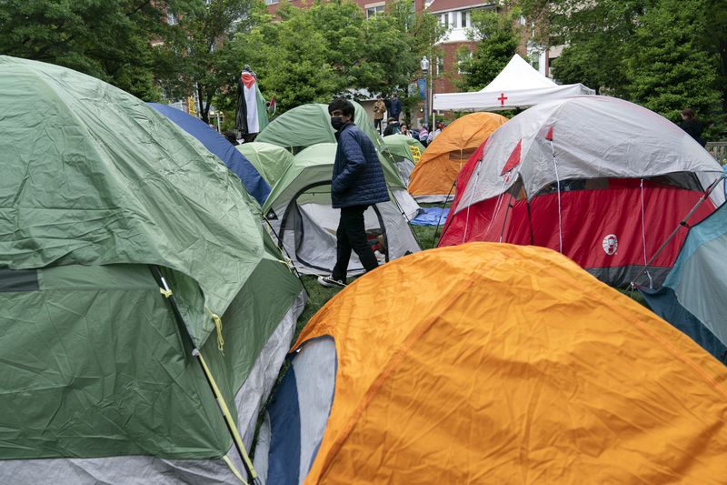 George Washington University students set up tents on the campus during a pro-Palestinian protests over the Israel-Gaza war on Thursday, April 25, 2024, in Washington. (AP Photo/Jose Luis Magana)