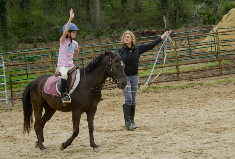 Minnie Black (left) rides a horse as she takes a lesson with instructor Tamara Dillard with Atlanta In-Town Riding Academy at Little Creek Horse Farm on April 3, 2013.  Jonathan Phillips Special