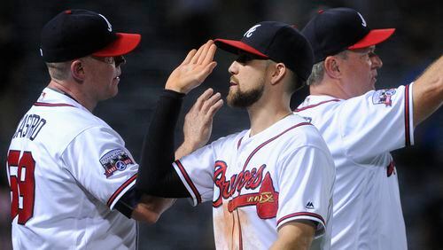 Atlanta Braves' Ender Inciarte, center celebrates with assistant hitting coach Jose Castro, left, as he comes off the field after a baseball game against the San Diego Padres, Wednesday, Aug. 31, 2016, in Atlanta. Atlanta won 8-1. (AP Photo/John Amis)