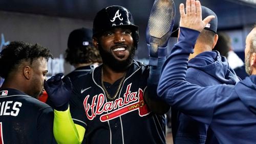 Atlanta Braves Marcell Ozuna (20) is congratulates by his teammates after scoring in the second inning of a baseball game against the Miami Marlins, Thursday, May 4, 2023, in Miami. (AP Photo/Marta Lavandier)