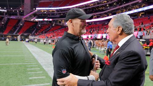 Falcons owner Arthur Blank greets coach Dan Quinn after an Aug. 26 exhibition game.