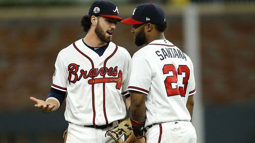 Shortstop Dansby Swanson #2 of the Atlanta Braves talks to second baseman Danny Santana #23 after the game against the San Francisco Giants at SunTrust Park on June 22, 2017 in Atlanta, Georgia.  (Photo by Mike Zarrilli/Getty Images)