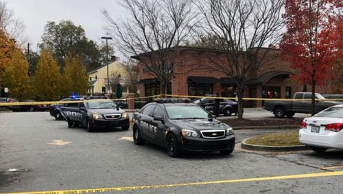 Police investigate the shooting at a DeKalb County shopping center Saturday afternoon.