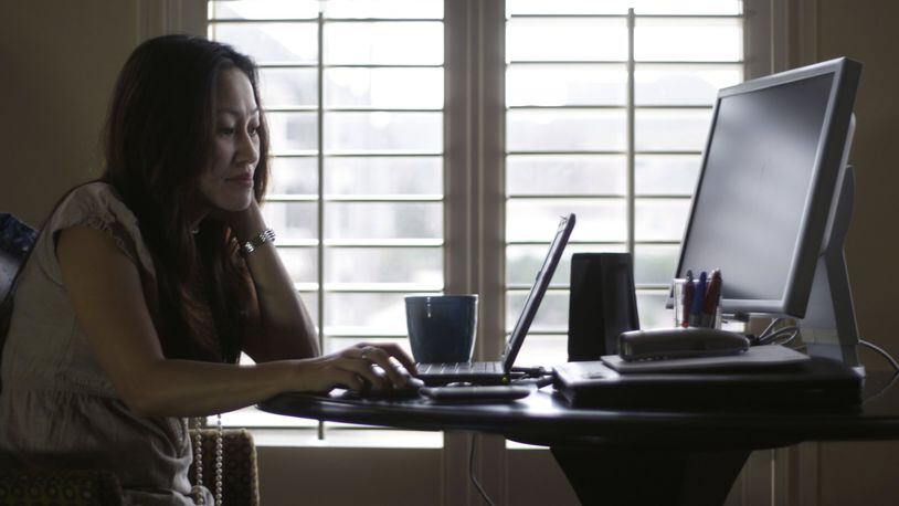 Denise Kenson-Liu (shown here in a 2011 photo) has been teleworking since about 2007, but experts say that in the wake of the coronavirus, this could become our new normal. BOB ANDRES / BANDRES@AJC.COM