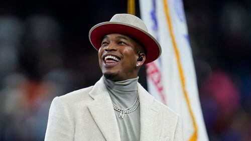 Ne-Yo smiles after singing the national anthem before an NFL football game between the Detroit Lions and Chicago Bears in Detroit, Thursday, Nov. 25, 2021. (AP Photo/Paul Sancya)