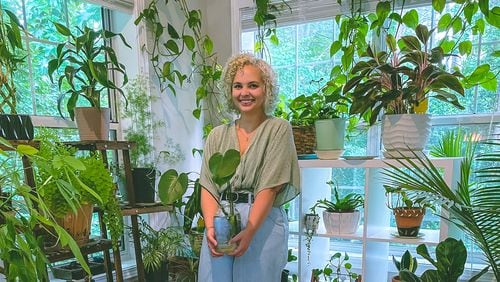 Mary Sanders poses with some of her 40-plus plants. 
Photo courtesy of Mary Sanders.