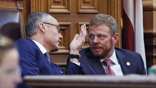 Lt. Gov. Casey Cagle and Chris Riley, Gov. Nathan Deal's chief of staff, confer in the Senate on the Delta/NRA flap. BOB ANDRES /BANDRES@AJC.COM