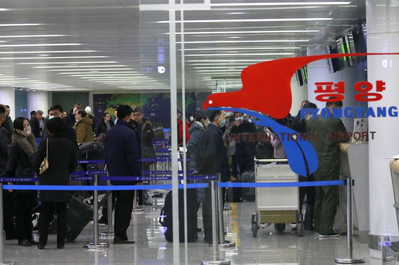FILE - Passengers wearing masks as a precaution against the new coronavirus line up to check in for a flight to Vladivostok, Russia, at the Pyongyang International Airport in Pyongyang, North Korea, March 9, 2020. North Korea is putting surveillance cameras in schools and workplaces, and collecting fingerprints, photographs and other biometric information from its citizens in a technology-driven push to monitor its population even more closely, a report said Tuesday, April 16, 2024. (AP Photo/Jon Chol Jin, File)
