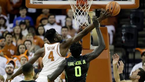 Texas forward Mohamed Bamba (4) and Baylor forward Jo Lual-Acuil Jr. (0) battle for a rebound during the first half of an NCAA college basketball game, Monday, Feb. 12, 2018, in Austin, Texas. (AP Photo/Eric Gay)
