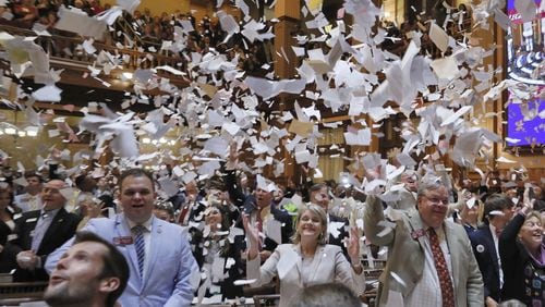 House members toss papers in the air as Sine Die was proclaimed shortly after midnight. Thursday was the 40th and final day of the 2018 General Assembly. BOB ANDRES /BANDRES@AJC.COM