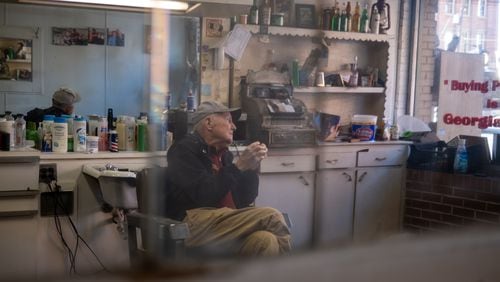 James “Soapy” Herndon sits at his shop, Soapy’s Barber Shop, in Americus on Saturday, March 4, 2023. Herndon was a longtime barber to Jimmy Carter. (Arvin Temkar / arvin.temkar@ajc.com)