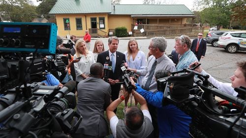 Members of the news media surround then-Secretary of State Brian Kemp, the Republican candidate for Georgia governor, after he cast his vote Nov. 6, 2018, at the Winterville Train Depot. The governor, now self-quarantining after close contact with somebody who has COVID-19, would violate Centers for Disease Control and Prevention guidelines if he voted in person on Tuesday. He has asked for an absentee ballot. Curtis Compton/ccompton@ajc.com
