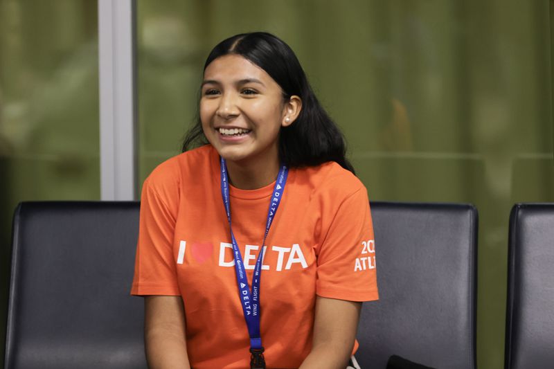 Leslie Santos Vega,15, smiles as she waits to board her first-ever flight on Friday, Sept. 22, 2023. Santos is a part of Delta Air Lines’ ‘Women Inspiring our Next Generation’ (WING) program, which sponsors an all-female charter flight that carries 100 young women interested in aviation from Atlanta to NASA’s Kennedy Space Center in Florida. (Natrice Miller/ Natrice.miller@ajc.com)