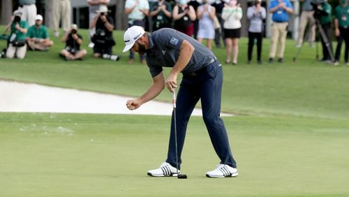 Dustin Johnson reacts after winning the 2020 Masters Tournament after sinking his putt on the 18th green Sunday, Nov. 15, 2020, at Augusta National. (Curtis Compton / Curtis.Compton@ajc.com)