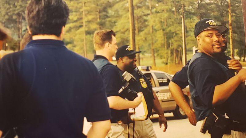 Merlin Ector, far right, at a crime scene. Ector was a smooth talking Georgia Bureau of Investigation undercover agent know for his humor and grace as well as his abilities.