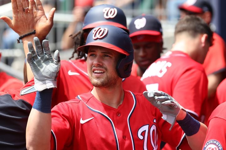 Nationals left fielder Lane Thomas is congratulated in the dugout after his sacrifice fly plated a run Wednesday at Truist Park. (Miguel Martinez/miguel.martinezjimenez@ajc.com)