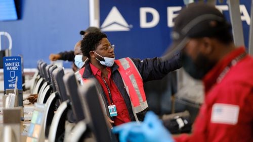 A Delta employee is seen at Hartsfield-Jackson airport in Atlanta on Friday, April 8, 2022.   (Arvin Temkar / arvin.temkar@ajc.com)