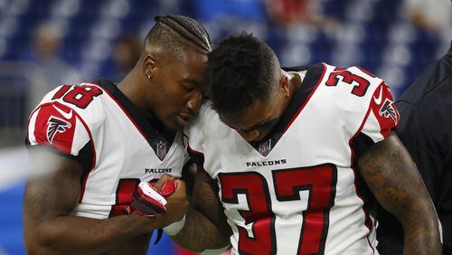 Atlanta Falcons wide receiver Taylor Gabriel (18) and free safety Ricardo Allen (37) connect during pre-game of an NFL football game against the Detroit Lions, Sunday, Sept. 24, 2017, in Detroit. (AP Photo/Paul Sancya)