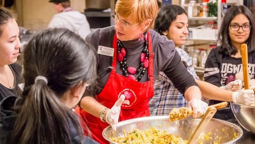 Suellen Daniels makes a batch of cookies with teen volunteers at Meals by Grace, the non-profit she founded in 2011 to help feed hungry school children. Contributed