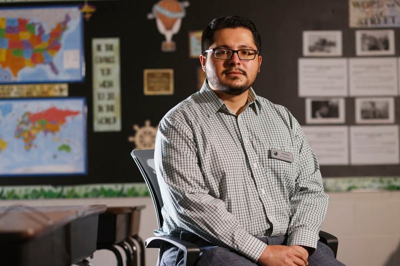 Daniel Garcia, a social studies teacher at Shiloh Middle School in Gwinnett, poses for a photograph in his classroom on Tuesday, Oct. 18, 2022. Garcia joined the Gwinnett district this school year after being part of the Idaho School District. (Miguel Martinez / miguel.martinezjimenez@ajc.com)