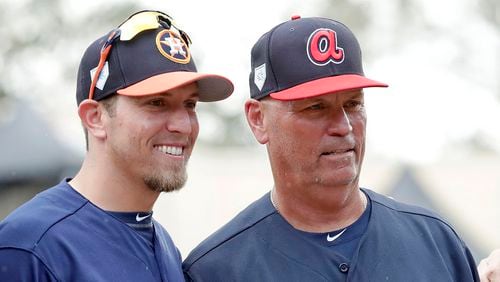 Houston Astros hitting coach Troy Snitker, (left) poses with his father, Braves manager Brian Snitker, before a spring exhibition game, Monday, March 4, 2019, in Kissimmee, Fla. No matter how this year’s World Series ends, a Snitker will get a championship ring.  (John Raoux/AP)
