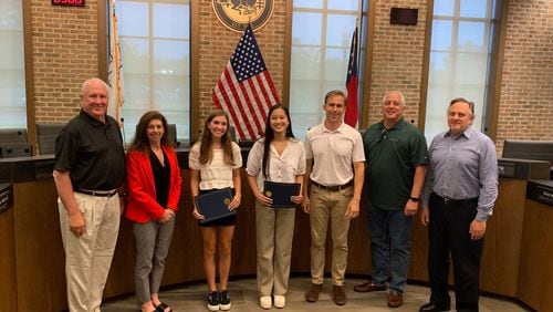 Milton’s Mayor and City Council recently recognized Milton High School seniors Ella Katekovich and Jeslyn Guo for their enthusiasm, commitment, and initiative to bring glass recycling back to the city. (Courtesy City of Milton)