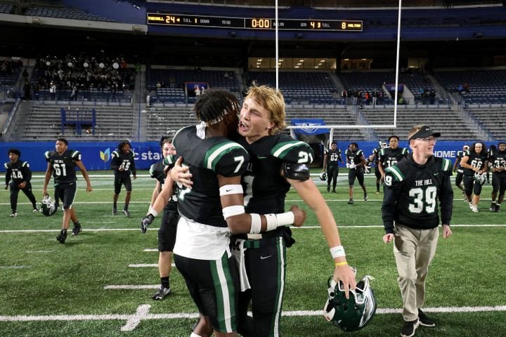 Collins Hill defensive back Jayden Davis (7) and quarterback Sam Horn (21) celebrate their 24-8 win against Milton in the Class 7A state title football game at Georgia State Center Parc Stadium Saturday, December 11, 2021, Atlanta. JASON GETZ FOR THE ATLANTA JOURNAL-CONSTITUTION