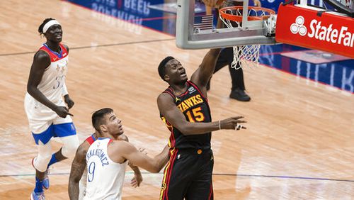 Atlanta Hawks center Clint Capela (15) shoots past New Orleans Pelicans center Willy Hernangomez (9) in the second quarter of an NBA basketball game in New Orleans, Friday, April 2, 2021. (AP Photo/Derick Hingle)