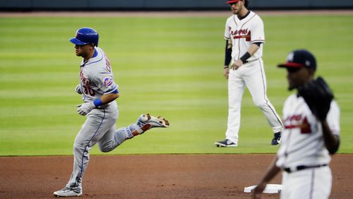New York Mets' Michael Conforto, left, rounds the bases after hitting a home run off Atlanta Braves starting pitcher Julio Teheran, right, in the first inning of a baseball game in Atlanta, Monday, May 1, 2017. (AP Photo/David Goldman)
