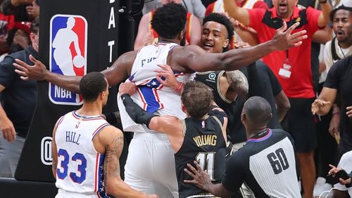 Philadelphia 76ers' Joel Embiid and the Hawks' John Collins have a scuffle during the 4th quarter.   “Curtis Compton / Curtis.Compton@ajc.com”
