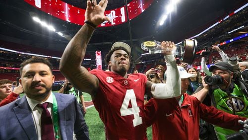 Alabama Crimson Tide quarterback and Most Valuable Player Jalen Milroe (4) celebrates as he walks from the field following the SEC Championship game at Mercedes-Benz Stadium in Atlanta, on Saturday, December 2, 2023. Alabama defeated Georgia 27-24 to end the Bulldogs’ 29-game win streak. (Jason Getz / Jason.Getz@ajc.com)