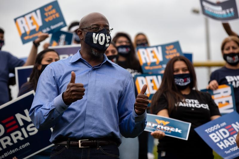US senate candidate Rev. Raphael Warnock meets campaign volunteers at the Get Out The Early Vote with Jon Ossoff, Rev. Raphael Warnock, Carolyn Bourdeaux, and the Biden Campaign at Shorty Howell Park in Duluth, Georgia, on Saturday, October 24, 2020. (Rebecca Wright for the Atlanta Journal-Constitution) 