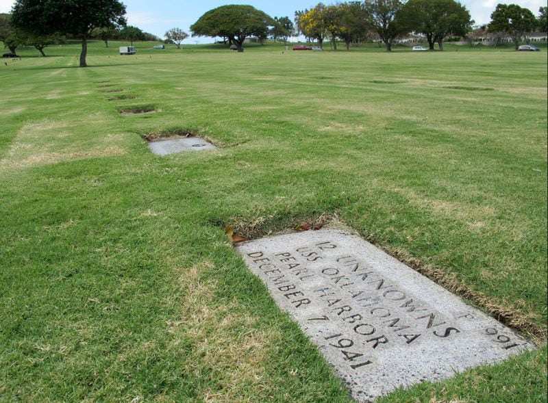 This April 21, 2015, photo shows a gravestone marking 12 sets of unidentified remains from the USS Oklahoma buried at the National Memorial Cemetery of the Pacific in Honolulu. 