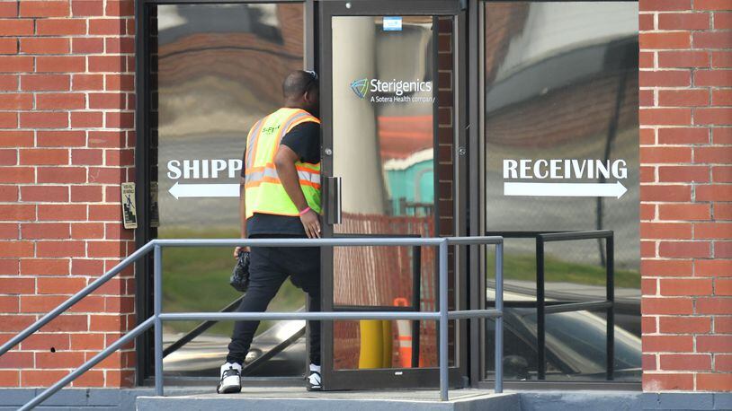 A man wearing a safety vest enters The Sterigenics plant in Smyrna on Thursday, March 26, 2020. Sterigenics recently resumed operations pending the outcome of an ongoing legal dispute with the county over its permitting. (Hyosub Shin / Hyosub.Shin@ajc.com)