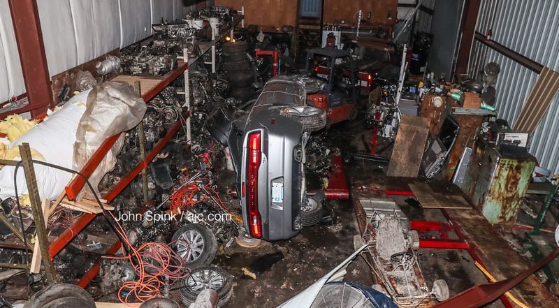 A car ran off Moreland Avenue, flipped and crashed into an auto repair shop Sun., Aug. 12. The shop's owners said that stretch of Moreland Avenue is notorious for street racing.
