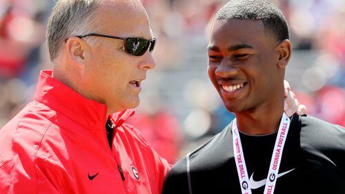 UGA head coach Mark Richt talks with Terry Godwin before the G-Day football game at Sanford Stadium in Athens on Saturday April 6, 2013. The Black team beat the Red 23 to 17.