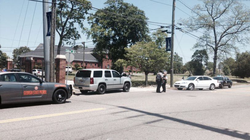 Photo of law enforcement officers near the intersection of Central Avenue and Oak Street in downtown Augusta after a shooting at Paine College on Monday May 5, 2014.