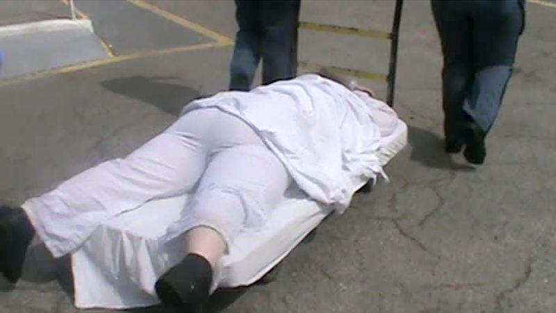 When Mollianne Fischer was unable to walk to an isolation cell, officers rolled her onto a flat cart and pulled her across the prison yard. This photo is from a prison video of the transfer.