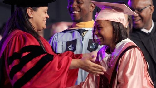 Atlanta Public School Superintendent Meria Carstarphen offers a hug to a student as she receives her diploma at the commencement ceremony for the Coretta Scott King Young Women's Academy High School and The Business Engineering Science and Technology (BEST) Academy at Benjamin S. Carson in 2015.  (Akili-Casundria Ramsess/Special to the AJC)