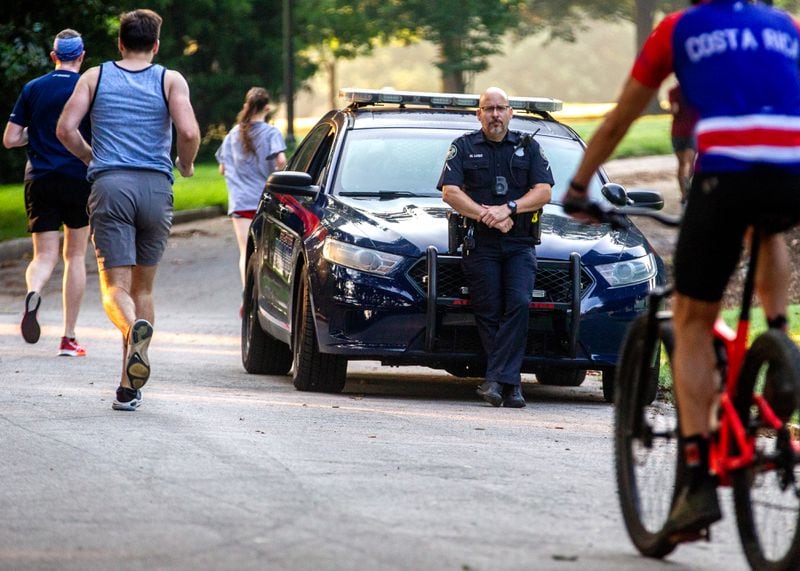 Atlanta police Officer Miguel A. Lugo stands watch in Piedmont Park early Thursday morning.