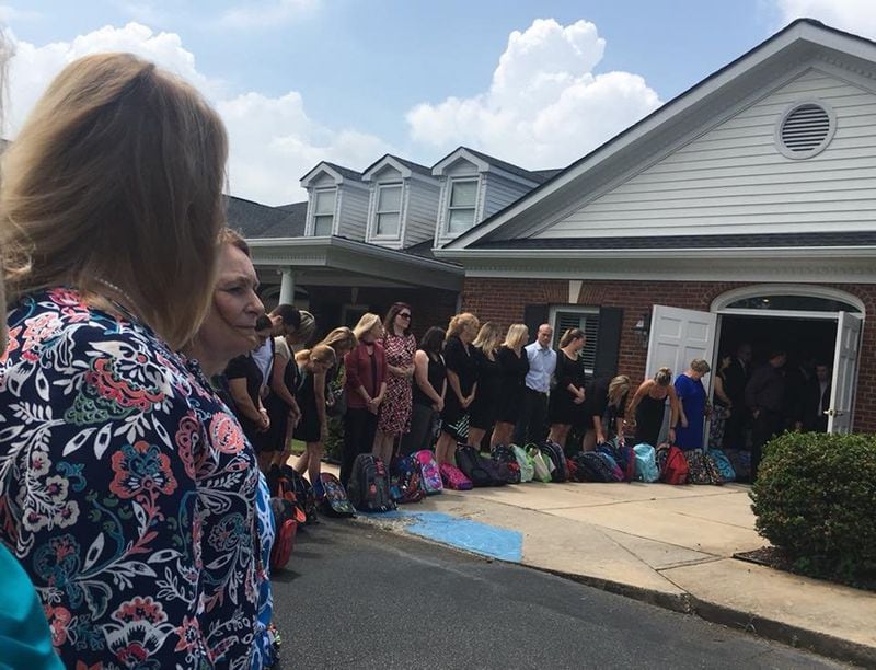 Honorary pallbearers, including fellow teachers, line up outside the chapel during the funeral service for Tammy Waddell.