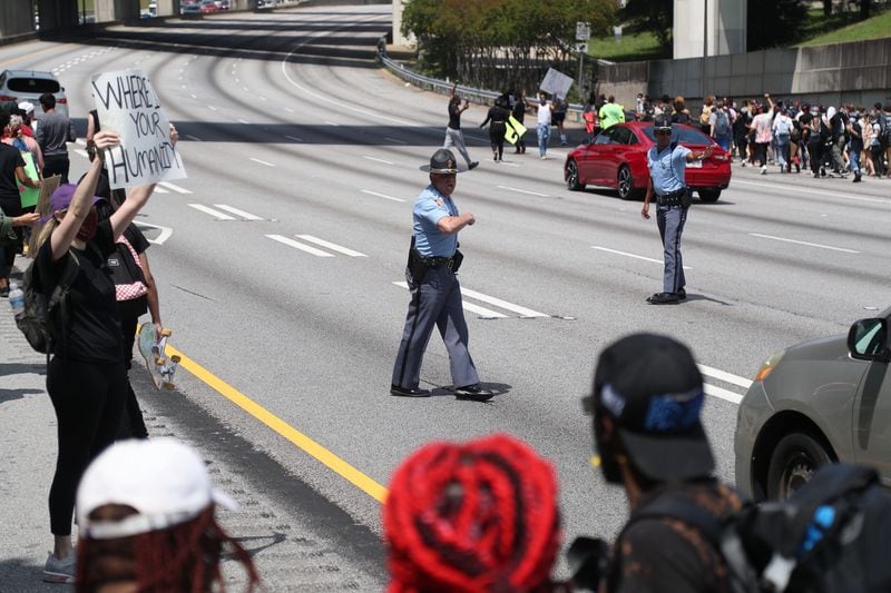 Protesters made their way to the Downtown Connector at Washington Street, blocking southbound traffic briefly.