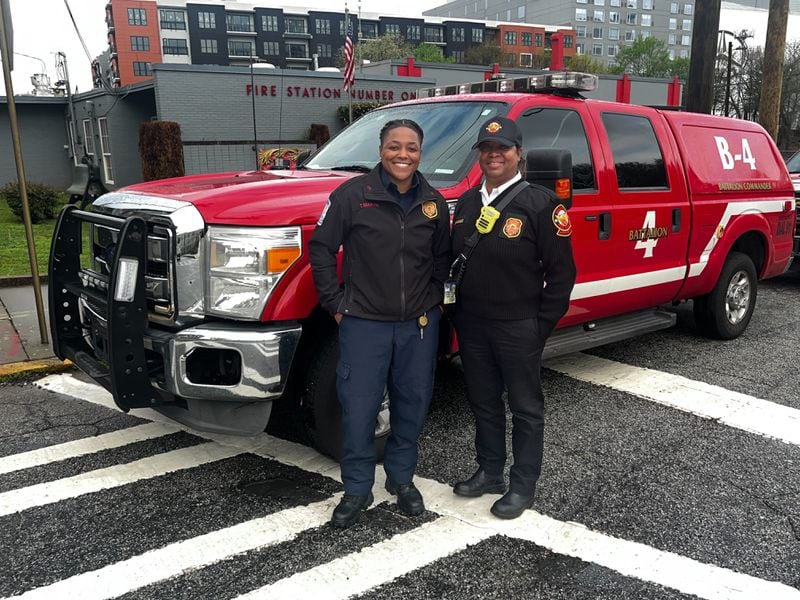 Te'Quila Martin (left) and Terese Cummings stand in front of the Battalion 4 command vehicle, which Martin drives.
