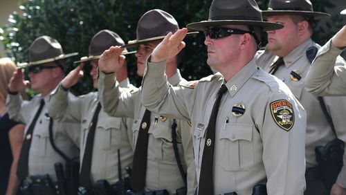 Members of the Pickens County Sheriffs Office salute the procession during the funeral of Polk County police Detective Kristen Hearne. A House bill would create a state-run peer-counseling program for first responders throughout the state to seek help with emotional concerns. Curtis Compton/ccompton@ajc.com
