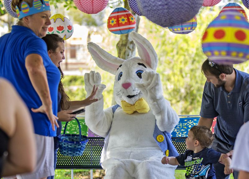 The Easter Bunny, aka Kristen Lehman, waves to children as they line up to have their picture taken with her, during the Easter Egg Hunt Saturday March 25, 2016, at the Jupiter Community Center. (Bill Ingram / The Palm Beach Post)