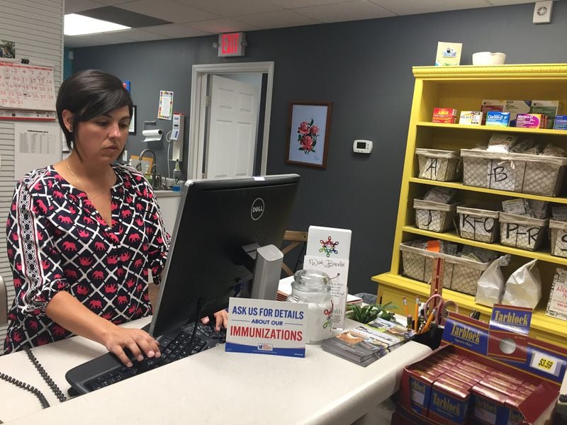 In Webster County, population 2,600, there is no doctor. Nikki Bryant is the lone pharmacist in Webster County, one of nine in the state without a doctor. Some in the Webster, with a poverty level of 21 percent, never see a doctor, she said. “At least once or twice a week there’ll be someone I’ll call and say, ‘You’ve got to get to the doctor’s office,’ ” Bryant said, “and they say, ‘Well I ain’t got a ride.’ ” (PHOTO by Ariel Hart/AJC)