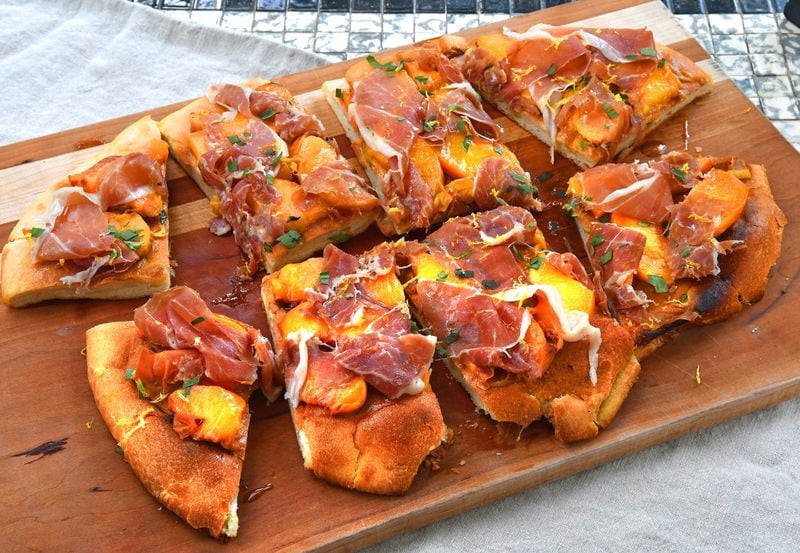 Peach and Prosciutto Flatbread is an easy recipe that turn store-bought pizza dough into peachy flatbread. This summery flatbread makes use of the broiler to cook and lightly char the dough. It then gets topped with similarly charred peaches, slivers of salty prosciutto, fresh tarragon and a dusting of lemon zest. Can also be made on the grill. (Chris Hunt for The Atlanta Journal-Constitution)
