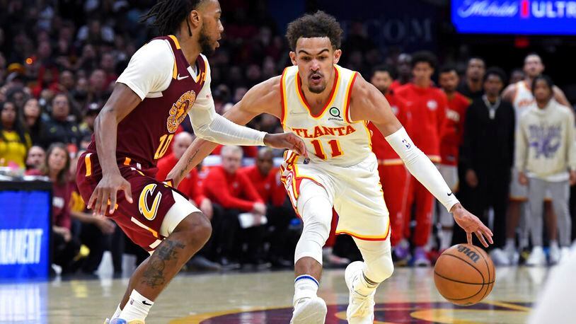 Atlanta Hawks' Trae Young (11) drives against Cleveland Cavaliers' Darius Garland (10) during the second half of an NBA play-in basketball game Friday, April 15, 2022, in Cleveland. (AP Photo/Nick Cammett)