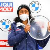 Elana Meyers Taylor from the United States poses at the award ceremony after winning the women's monobob at the Bobsled World Cup race in Igls, near Innsbruck, Austria in Igls, Austria, Saturday, Nov. 27, 2021. (AP Photo/Lisa Leutner)